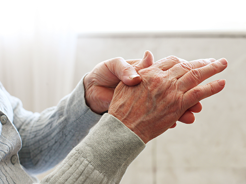 Person holding injured hand