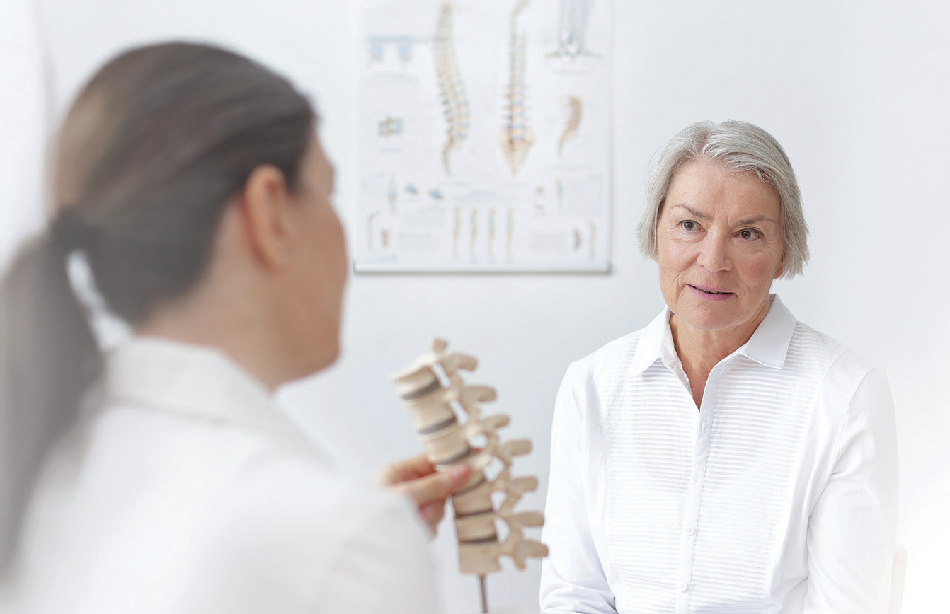 mature woman talking with bone doctor