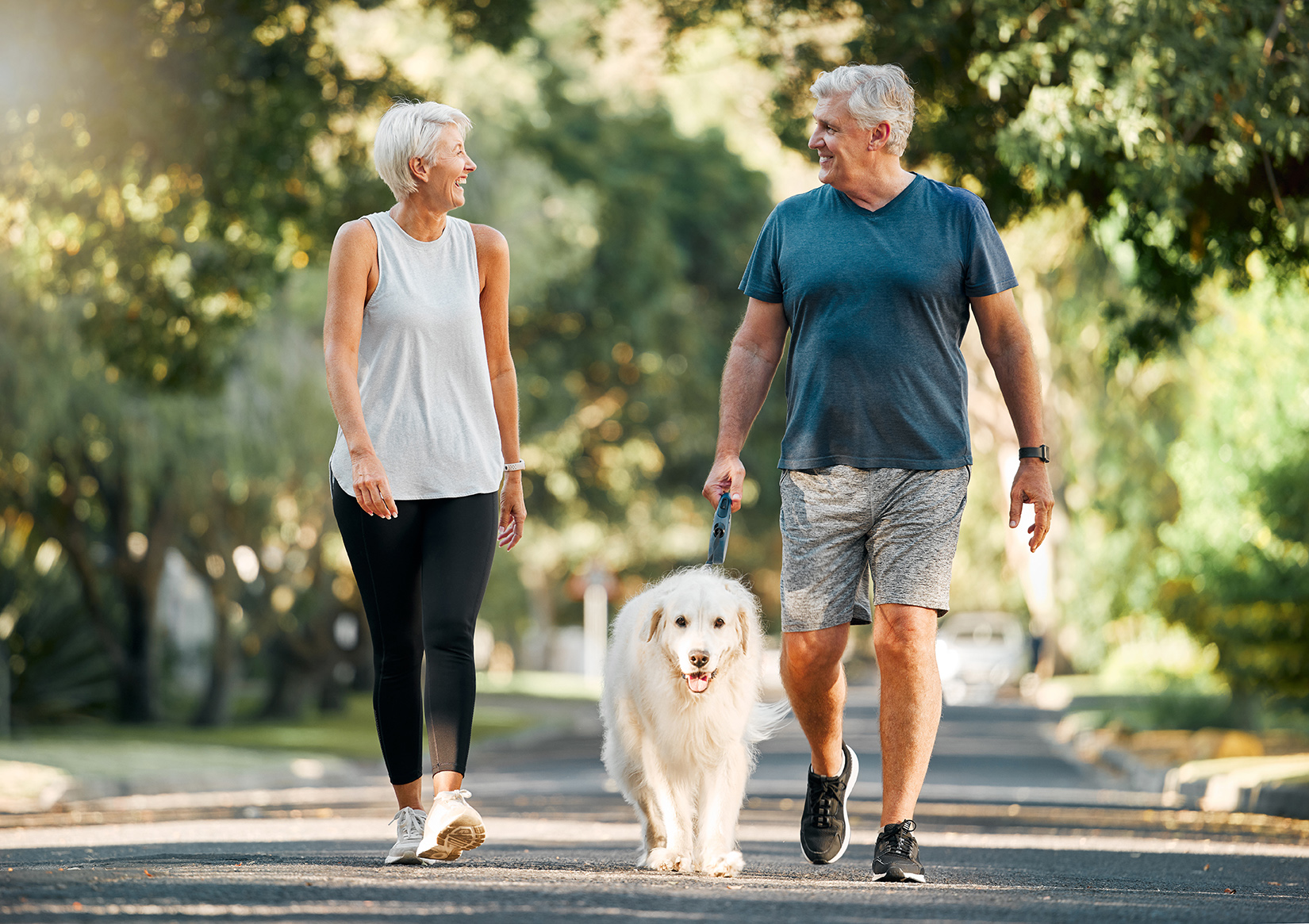 mature couple walking dog