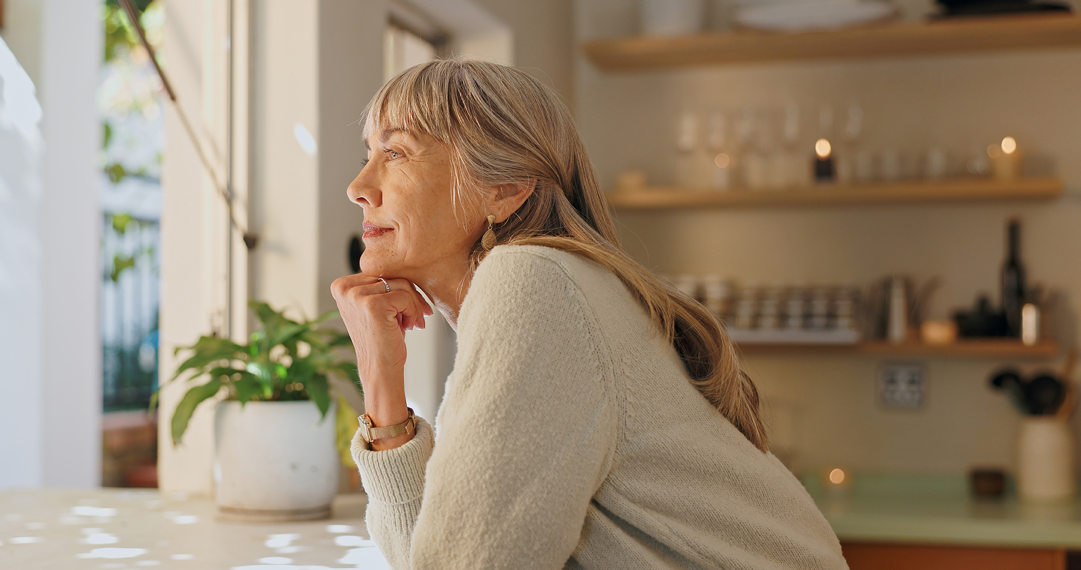 mature woman looking out window